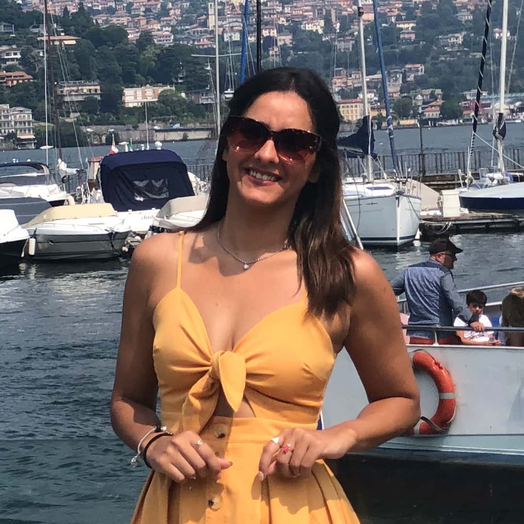 A woman in a yellow dress standing on a dock, captured for digital marketing purposes by a tourism marketing agency specializing in tours and activities.